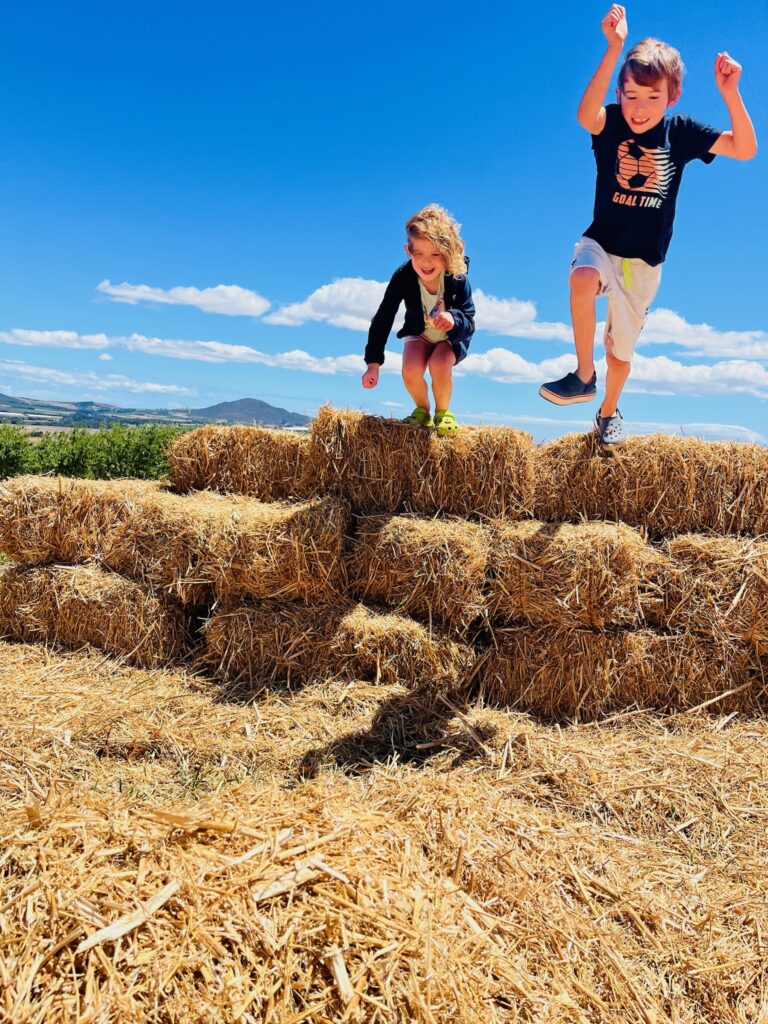 Vrymansfontein Kids jumping from hay