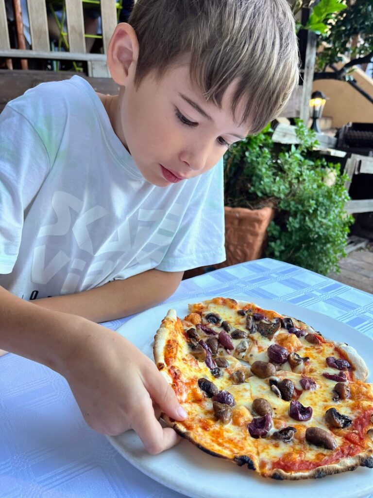 Cafe Paradiso Boy eating pizza