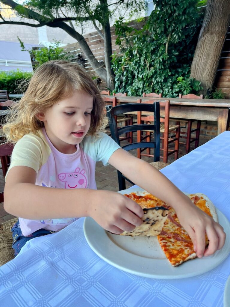 Cafe Paradiso Girl eating pizza