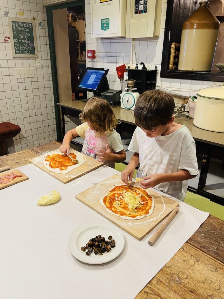 Cafe Paradiso Kids putting toppings on pizza